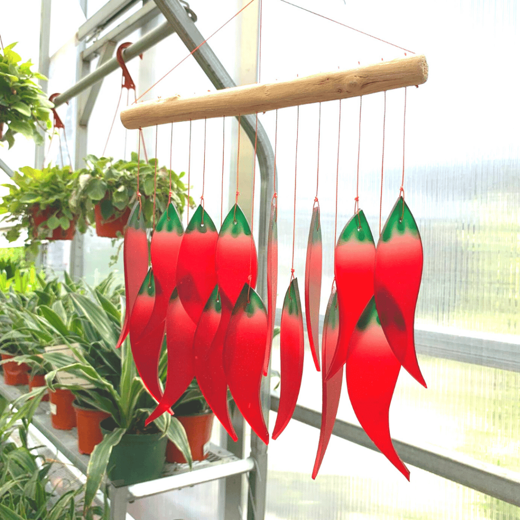 Colorful windchime with red and green shapes.